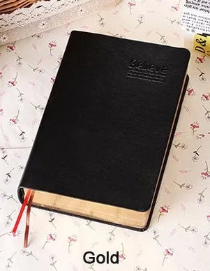 Large thick leather Phnom Penh notebook in gold, A6 size, 480 pages, open on a desk