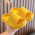 Bright coloured children's EVA slippers with textured sole, shown in blue, green, orange, pink, and yellow.