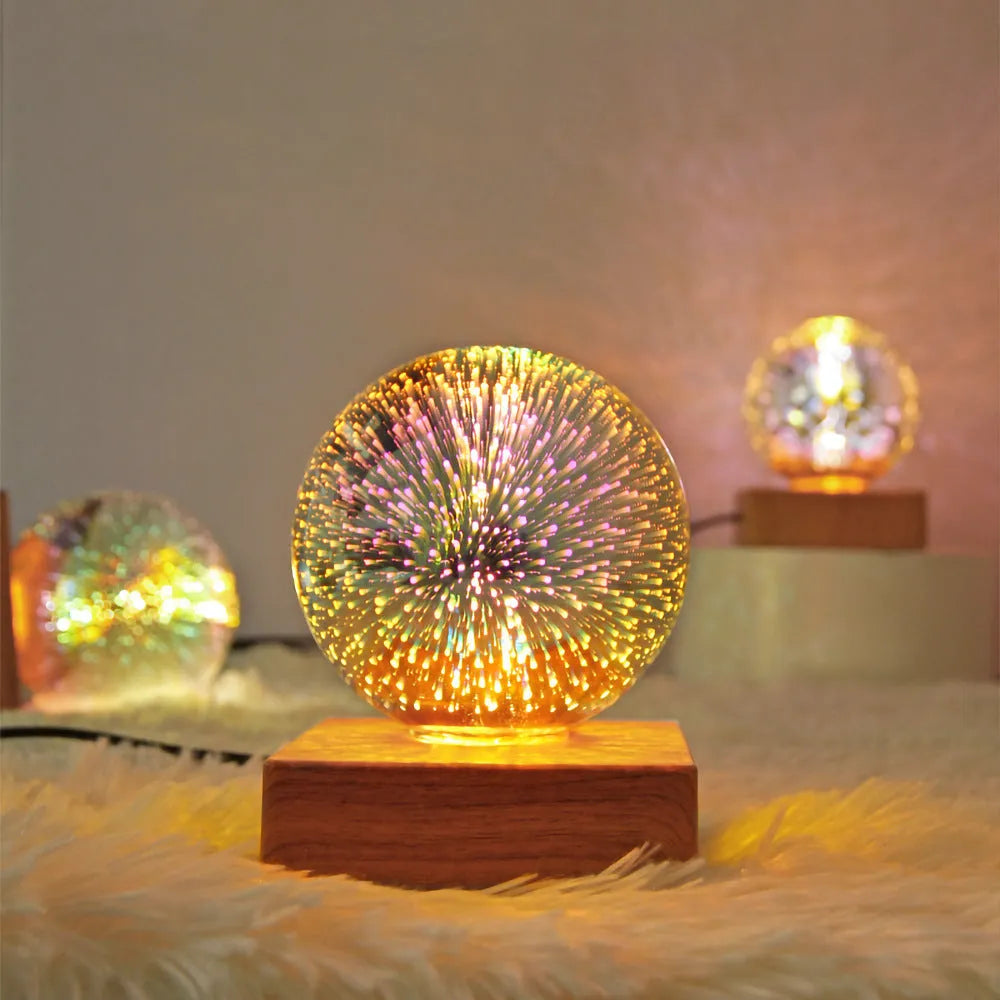 USB plug-in crystal ball night light displaying colourful firework pattern on a dark surface.
