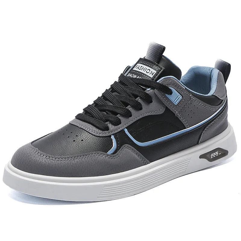 Men's low-top canvas shoes in grey with leather stitching detail on a white background