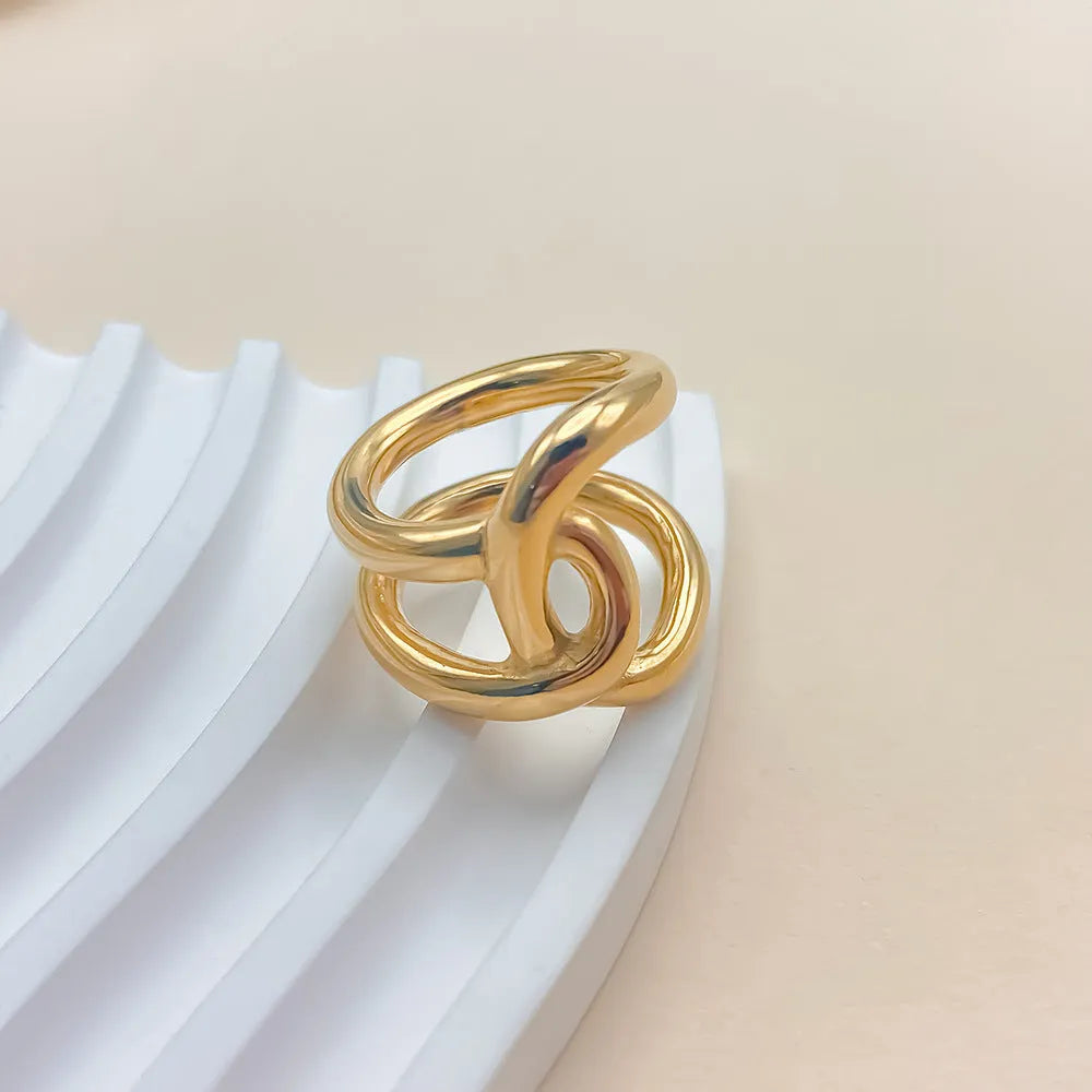 Adjustable knotted stainless steel ring for women in 18K gold or steel colour, showing U-shaped geometric design.
