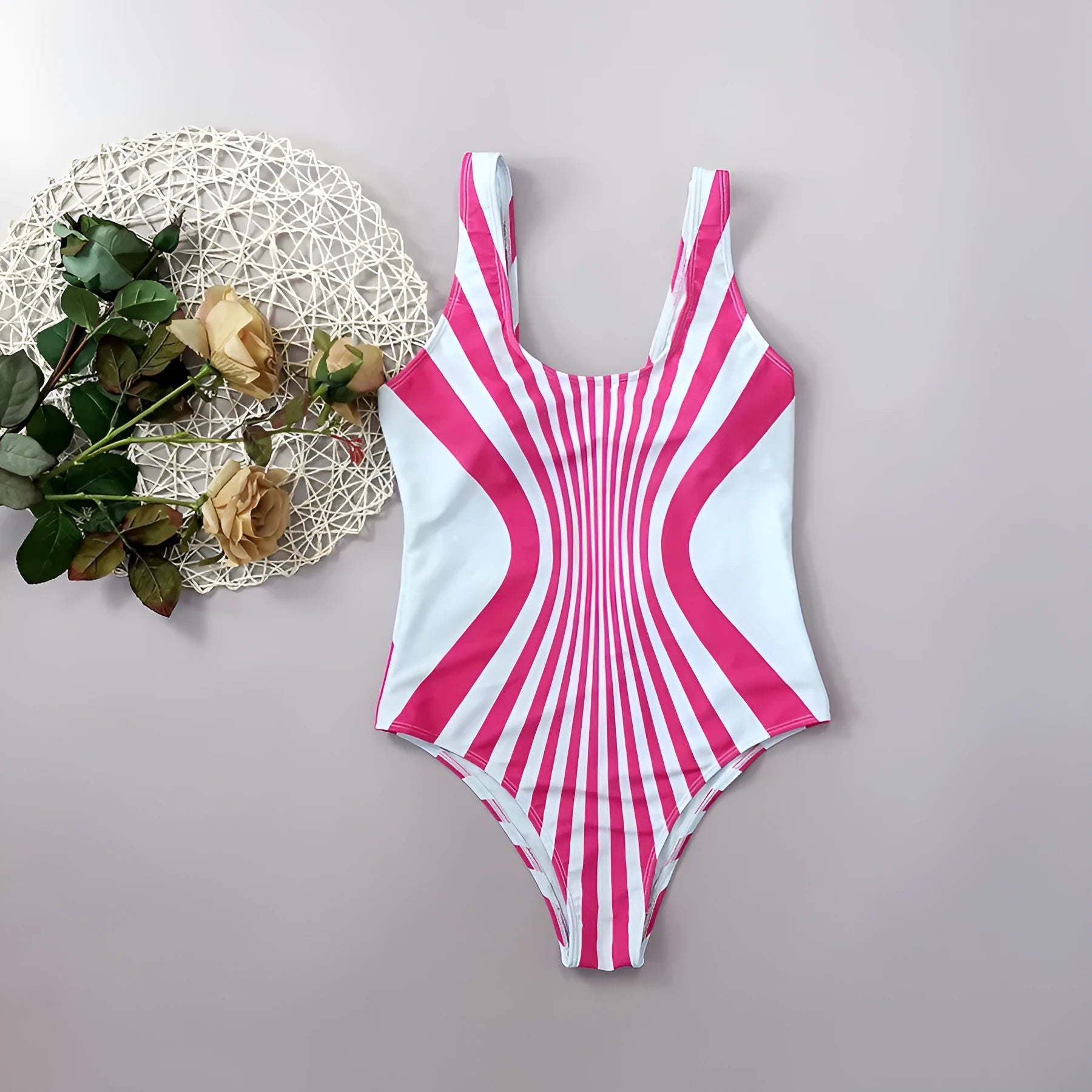 Pink striped one-piece swimsuit for women on a mannequin, showing front and rear digital print detail.