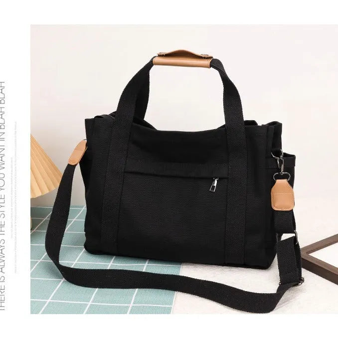 Canvas tote bag with internal organisation pockets for phone, documents, laptop, and camera in horizontal square shape