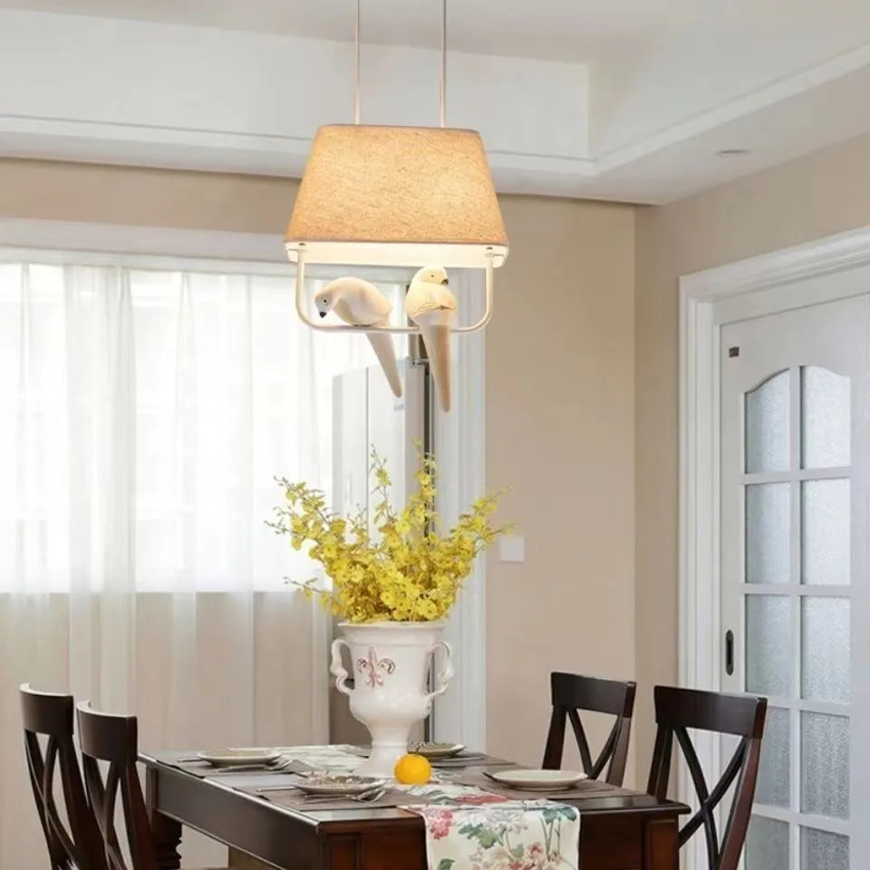 Iron and fabric bird chandelier ceiling lamp with decorative bird silhouette shade.