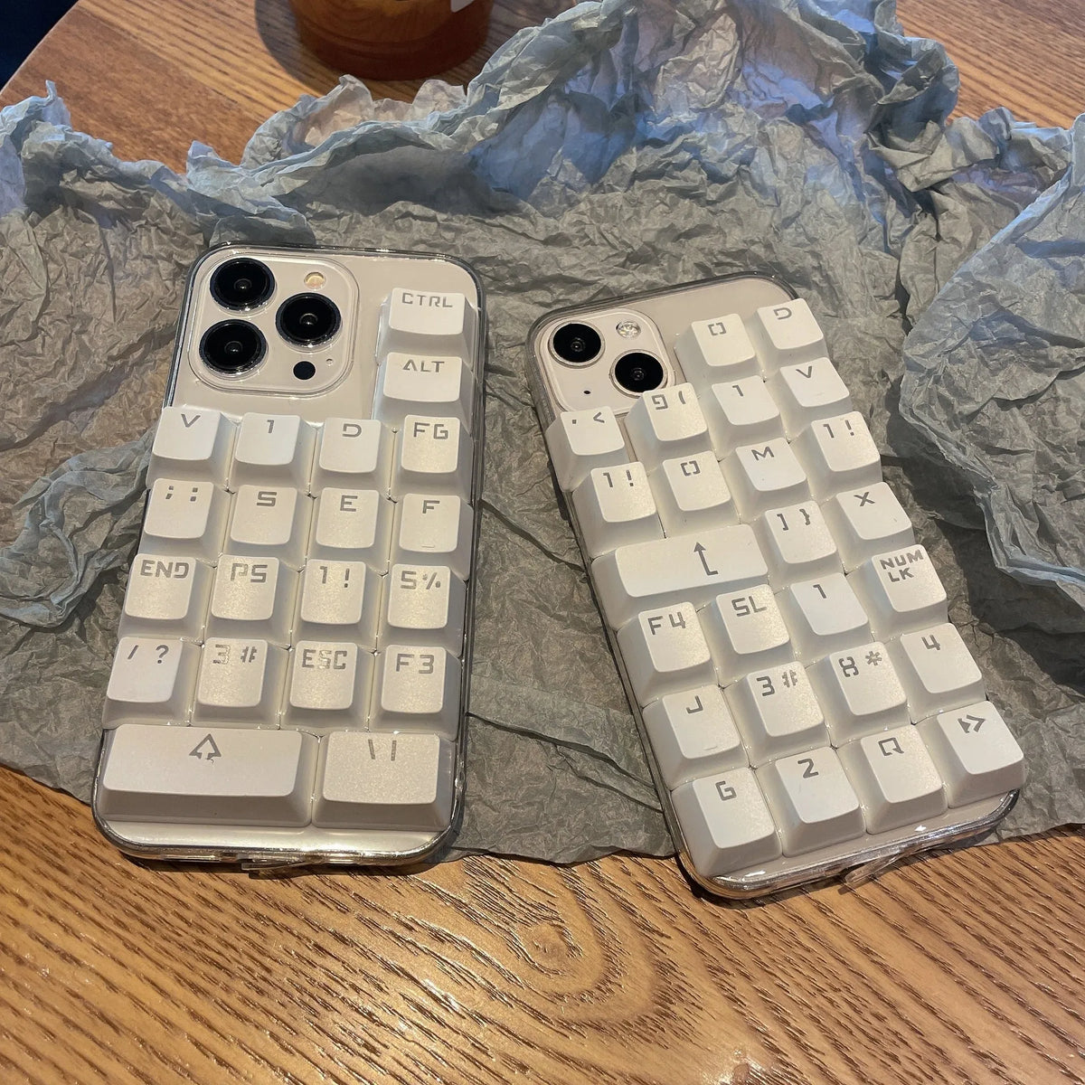 Creative keyboard mobile phone case with dripping glue material in keyboard colour, back cover type for Apple iPhone models.