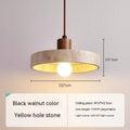 Small yellow cave stone and solid wood pendant light on a bedside table, 21 cm diameter, wood colour option