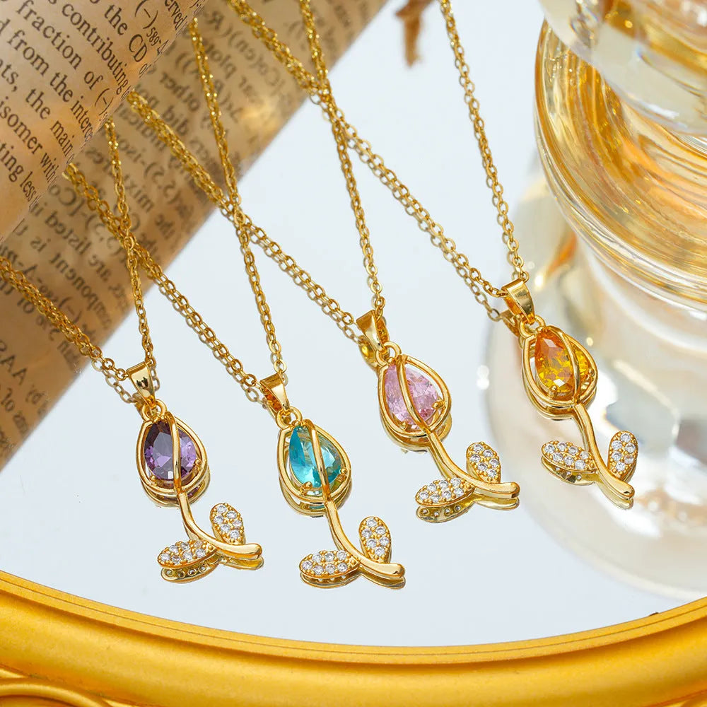 Gold tulip pendant necklace on an adjustable O-ring chain, showing non-fading electroplated finish.
