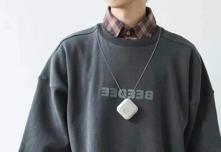 Mini USB portable air purifier necklace in blue, shown worn and with USB cable.