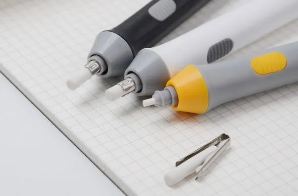 Black electric eraser with plastic body and geometric design on a white background