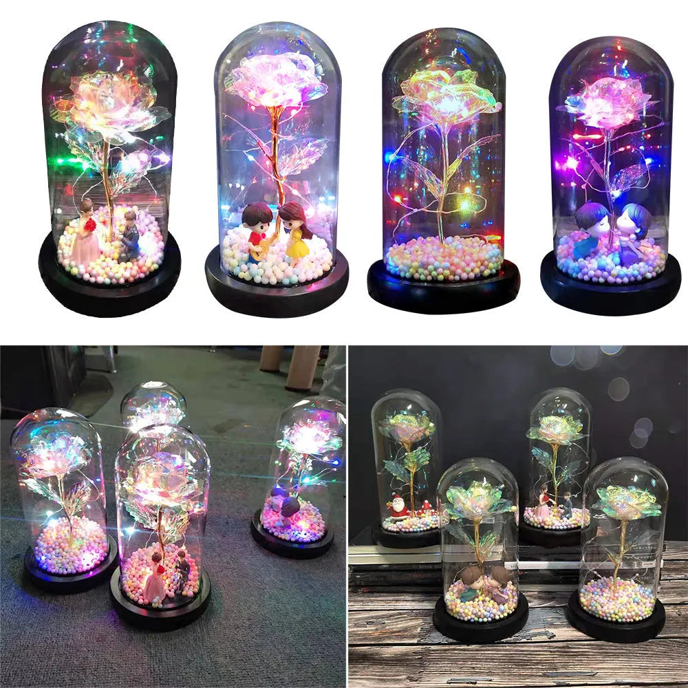 Artificial gold rose in clear glass dome on black base with LED lights for home decor