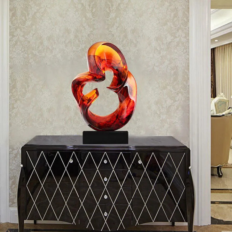 Glass transparent resin craft ornament sculpture in modern simplicity style, shown in orange red and blue colour options.