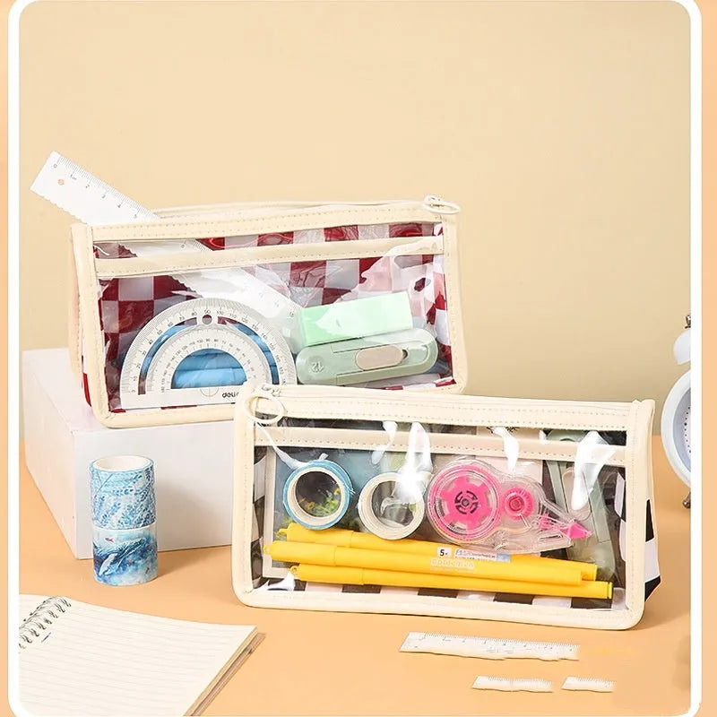 Large transparent PVC pencil case with internal black and white chessboard grid design.