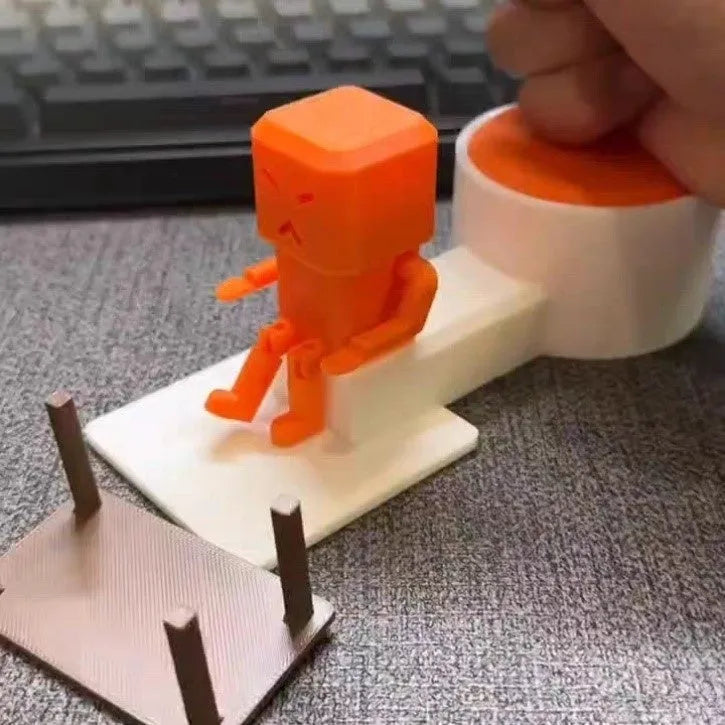 Orange plastic vent decompression toy on a table, dimensions 16cm by 6cm by 7cm.