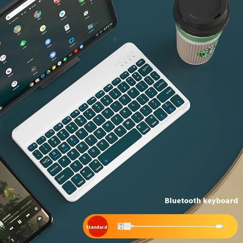 Bluetooth keyboard and matching rechargeable mouse set in elegant pink colour on a desk next to a tablet.