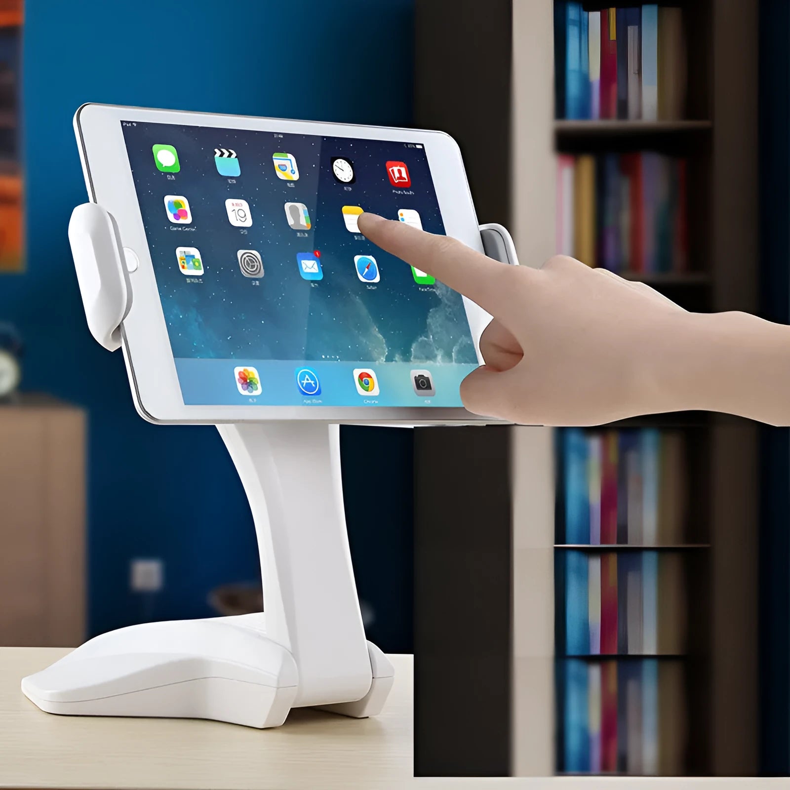 White aluminium tablet stand on a desk, showing its height and the adjustable clip for 7-15 inch devices.
