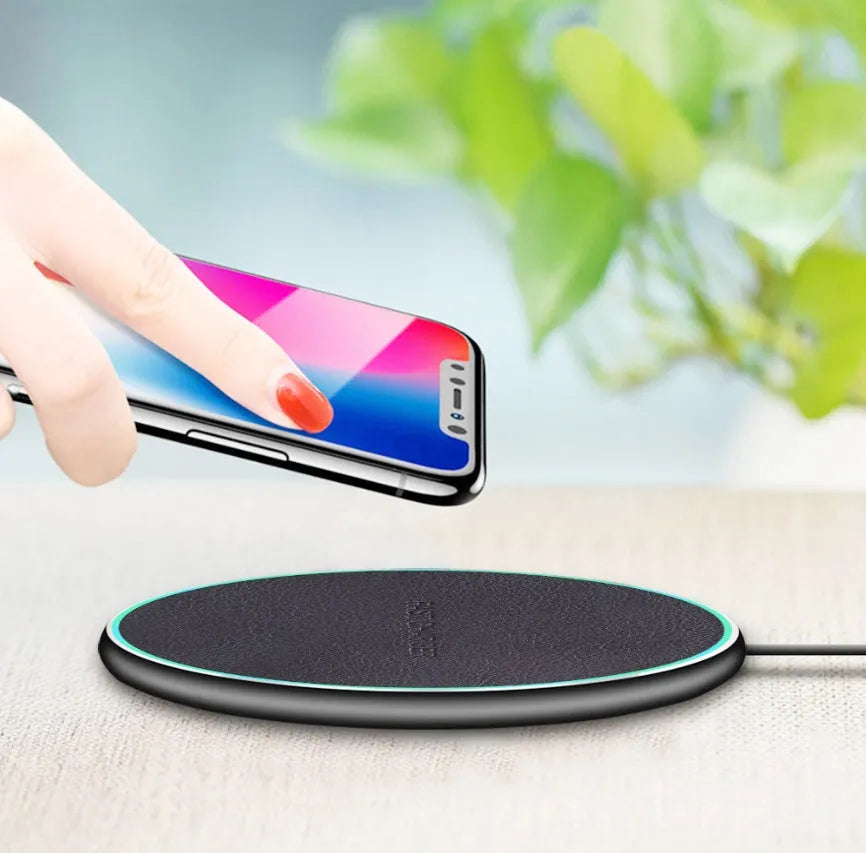 Black circular Qi wireless charger for iPhone 11 with non-slip base