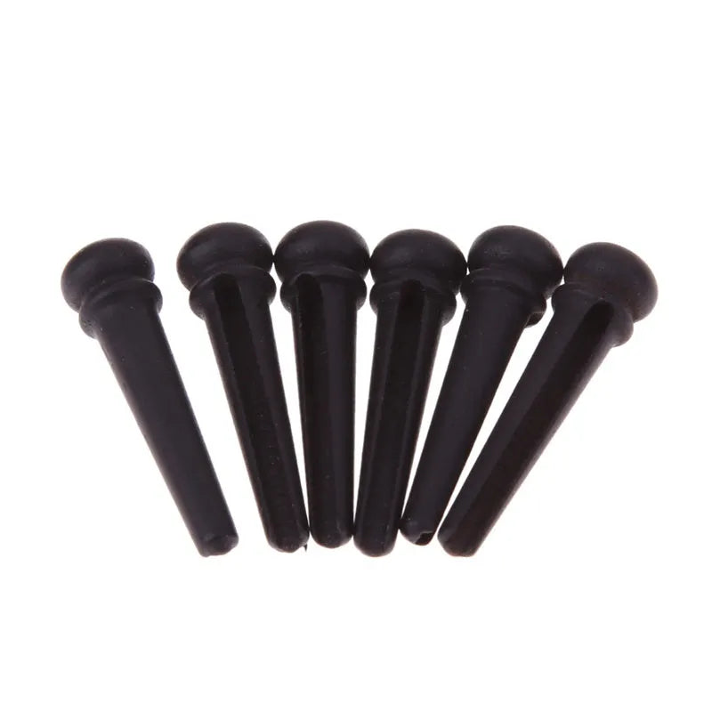 Six ebony guitar bridge pins with matt black finish and 5.3mm bayonet diameter