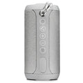 Compact portable outdoor Bluetooth speaker in black, showing control buttons and a speaker grille.
