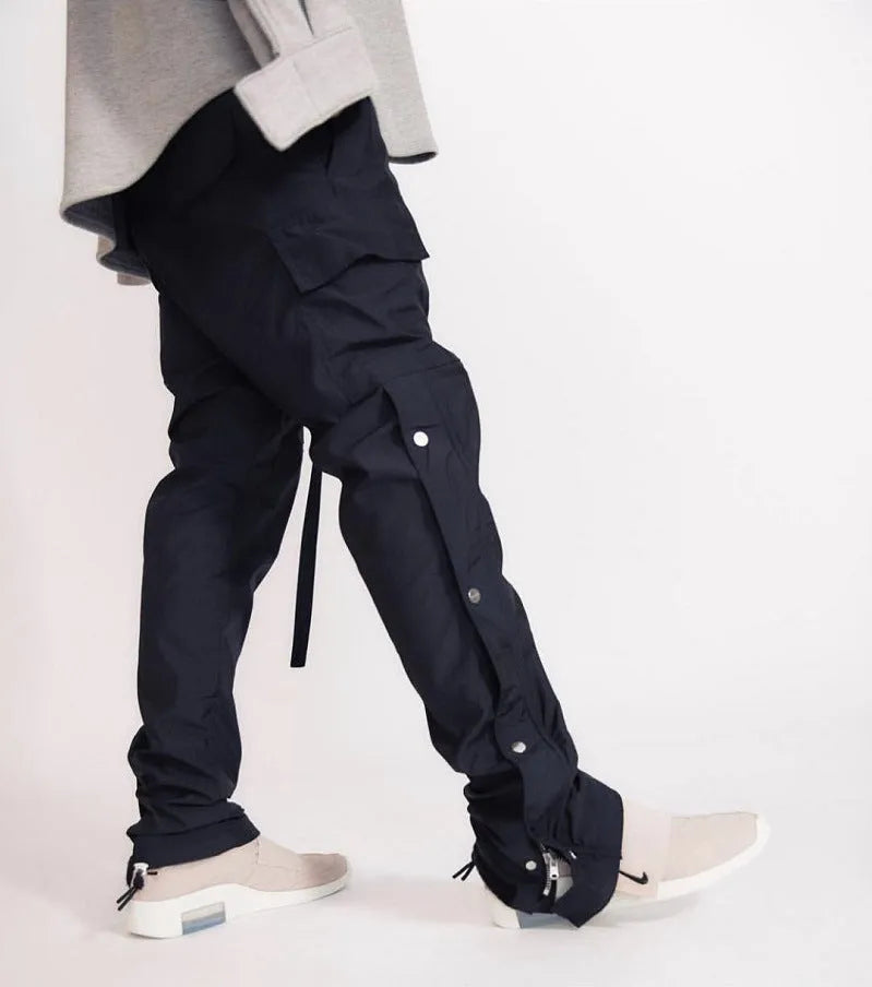Men's cotton cargo pants with green colour, straight leg, and Velcro button closure on black background