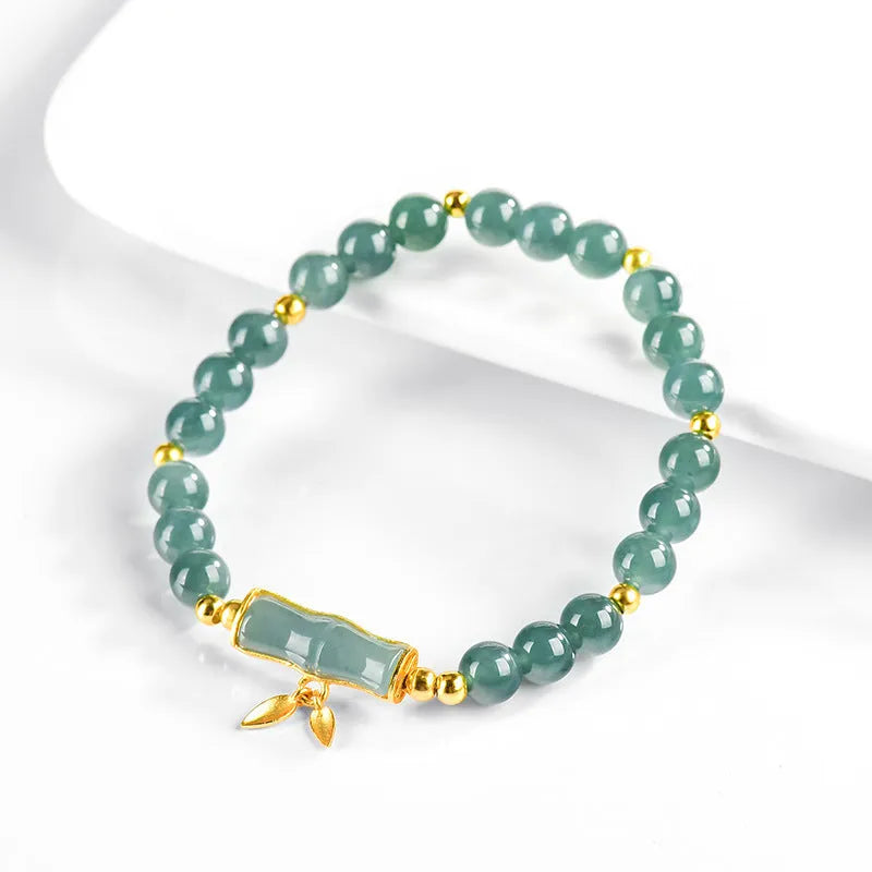 Women's silver bracelet with natural jade and blue beads in a simple high-rise design.
