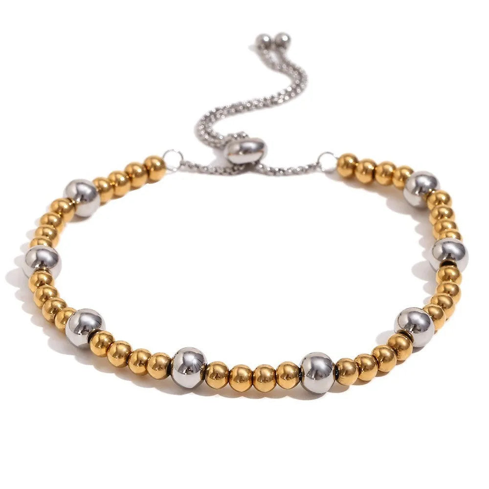 Gold geometric stainless steel jewellery set showing earrings, bracelet, and necklace on a plain background.