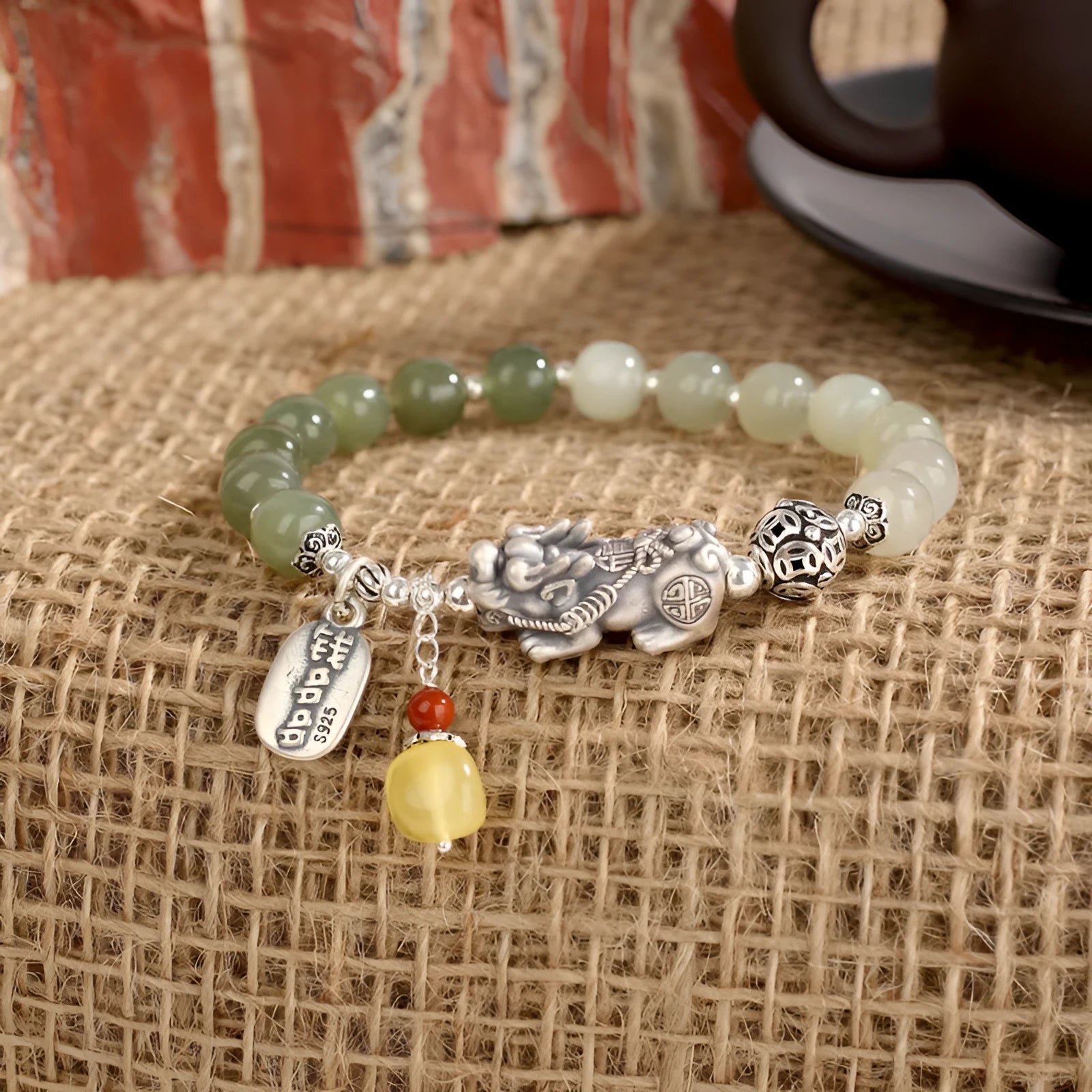 Retro women's silver coin bracelet with a natural Hetian jade stone.