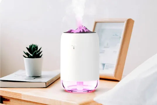 Compact cylindrical mini USB humidifier in turquoise green with a single mist outlet and night light.