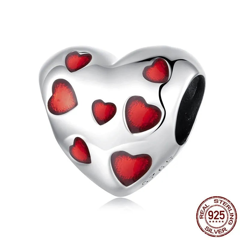 Red heart-shaped S925 sterling silver bead with glossy drip oil finish on plain background