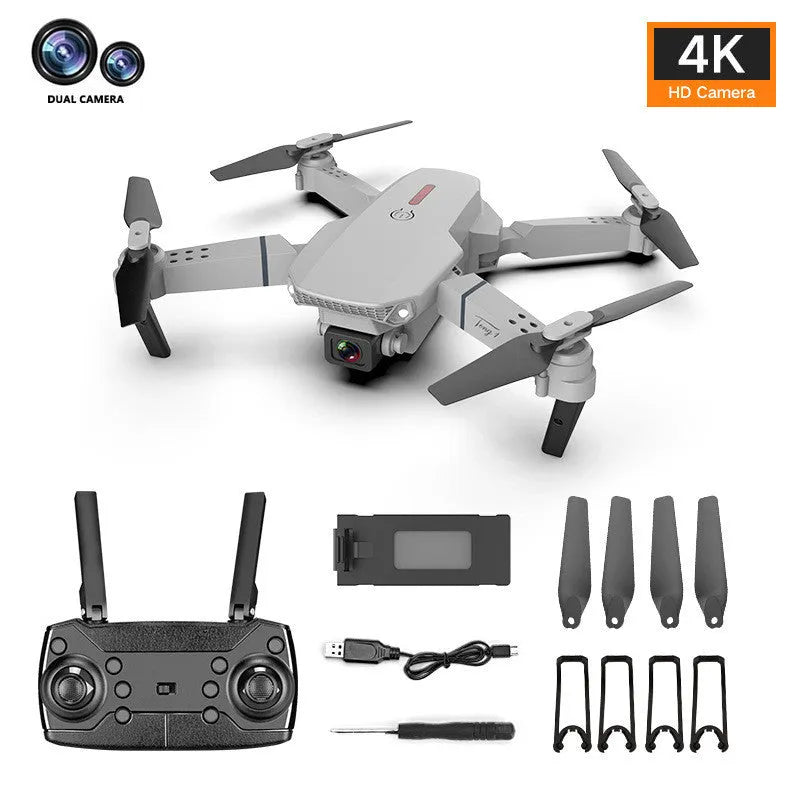 Grey foldable 4K dual camera drone with remote controller and carry bag, shown with propeller blades extended.