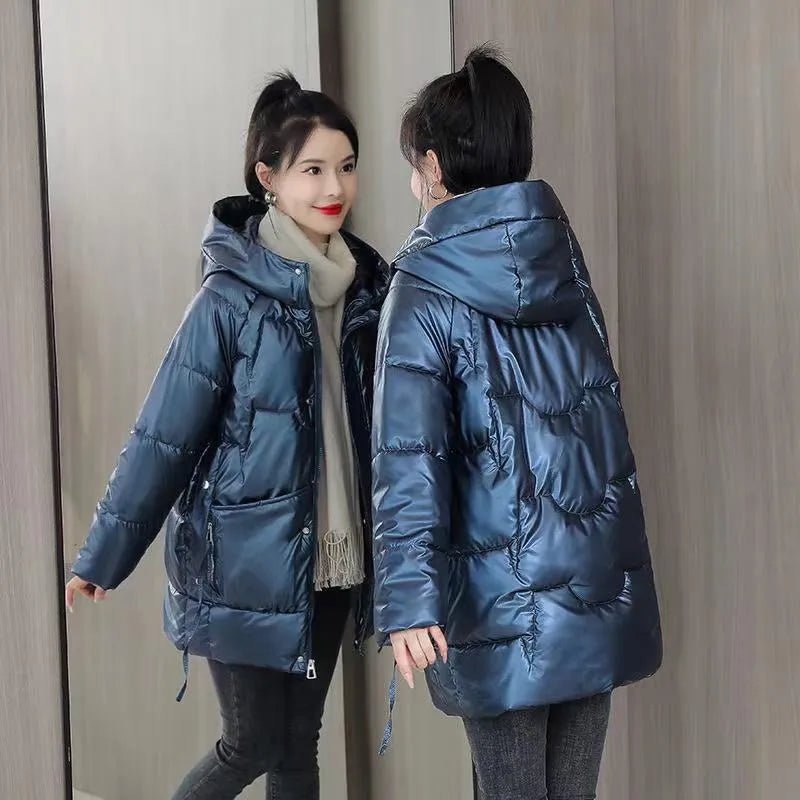 A woman wearing a loose-fit forest green hooded winter jacket, showcasing its relaxed silhouette and long sleeves.