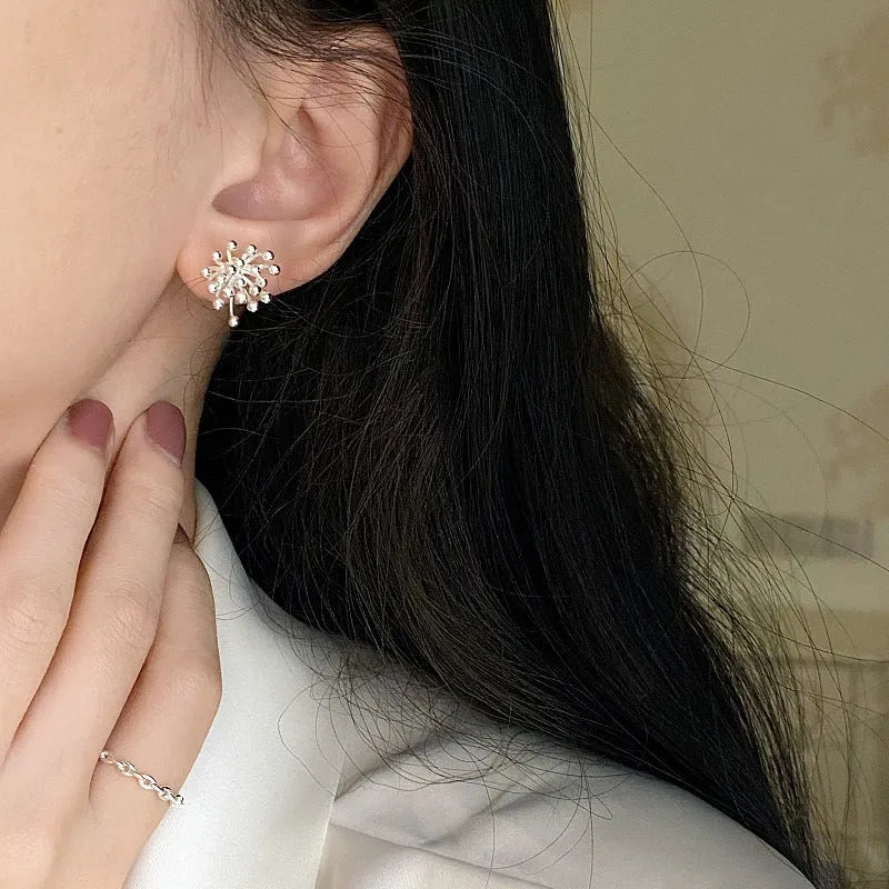 Women's silver needle stud earrings with electroplated dandelion fireworks geometric design on white background