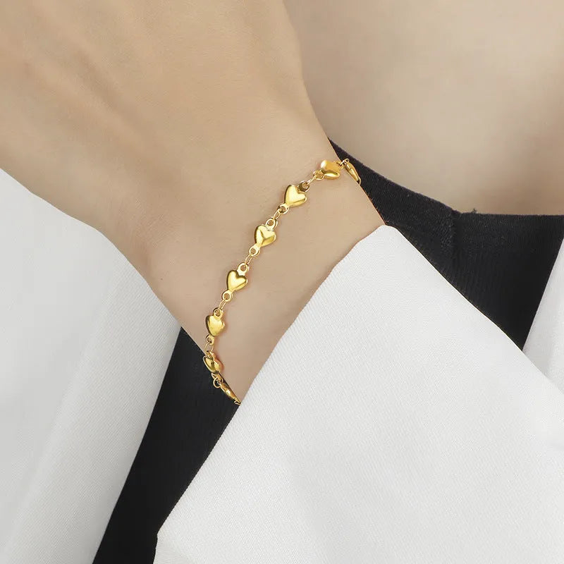Titanium steel gold chain heart bracelet electroplated colour for women on white background