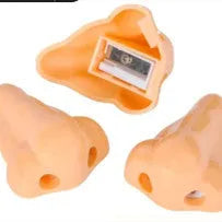 Flesh-coloured plastic pencil sharpener with large nostril and geometric shape on a white background.