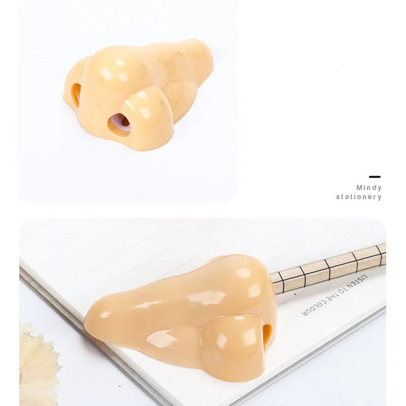 Flesh-coloured plastic pencil sharpener with large nostril and geometric shape on a white background.