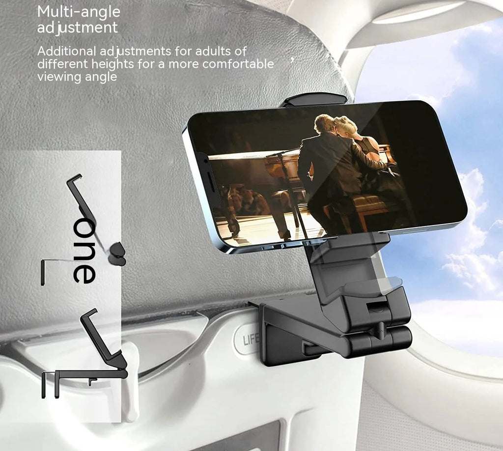 Black foldable rotating universal phone holder made of ABS plastic on a table.