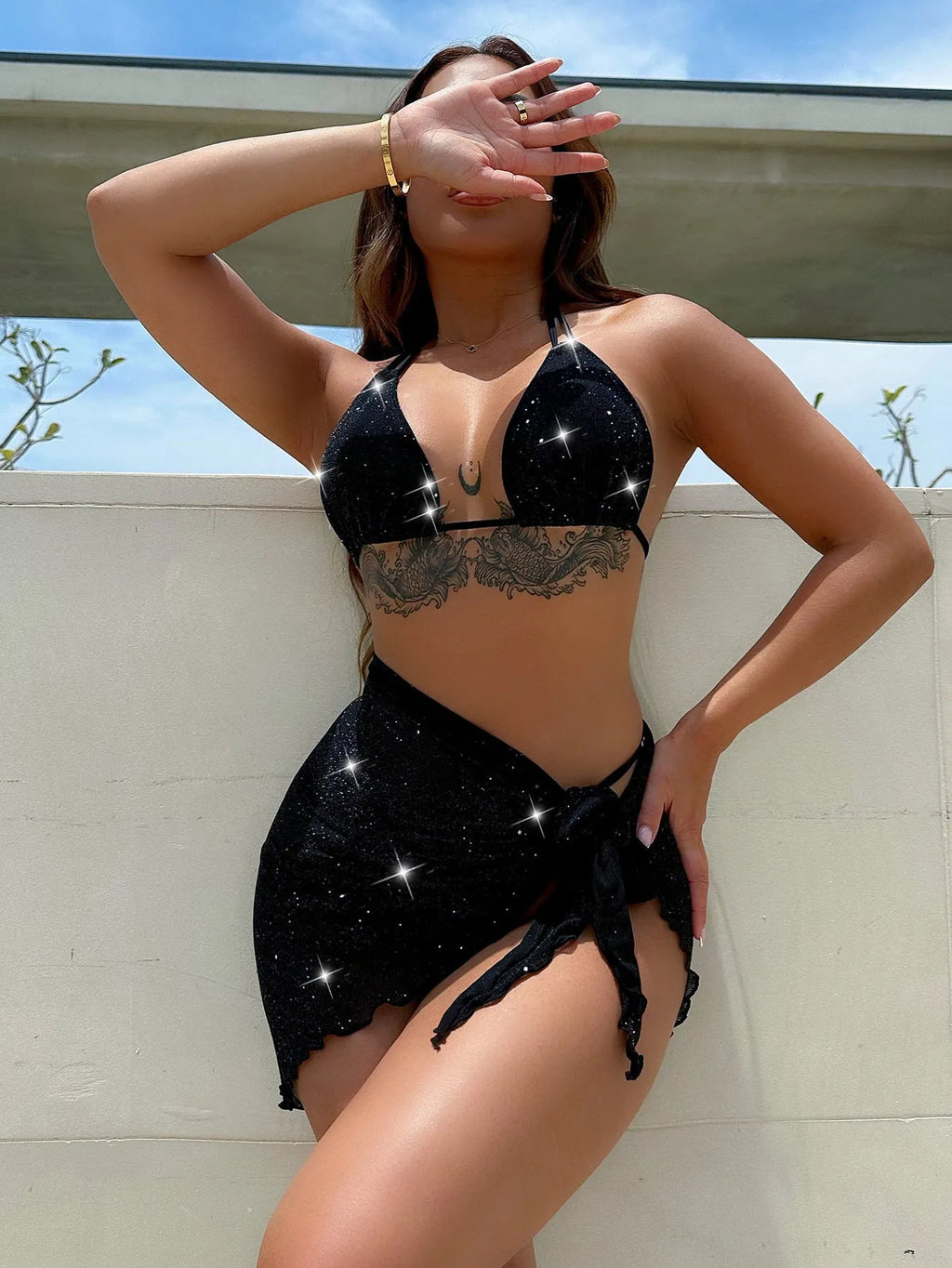 Black three-piece bikini swimsuit set with matching top and shorts on white background