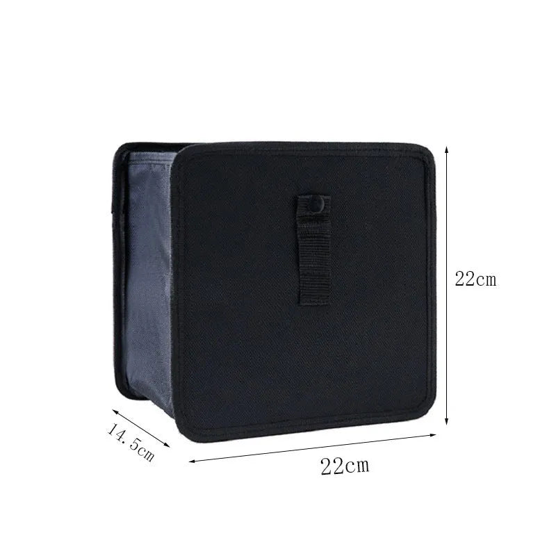 Black hanging car trash can made from Oxford cloth, showing its size and hanging loop.