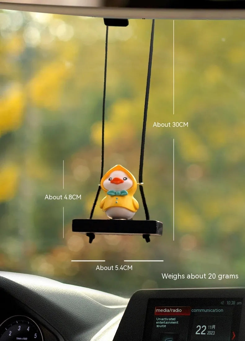 Colourful plastic cartoon duck car hanging ornament on a rear-view mirror.