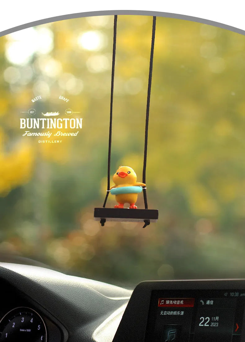 Colourful plastic cartoon duck car hanging ornament on a rear-view mirror.