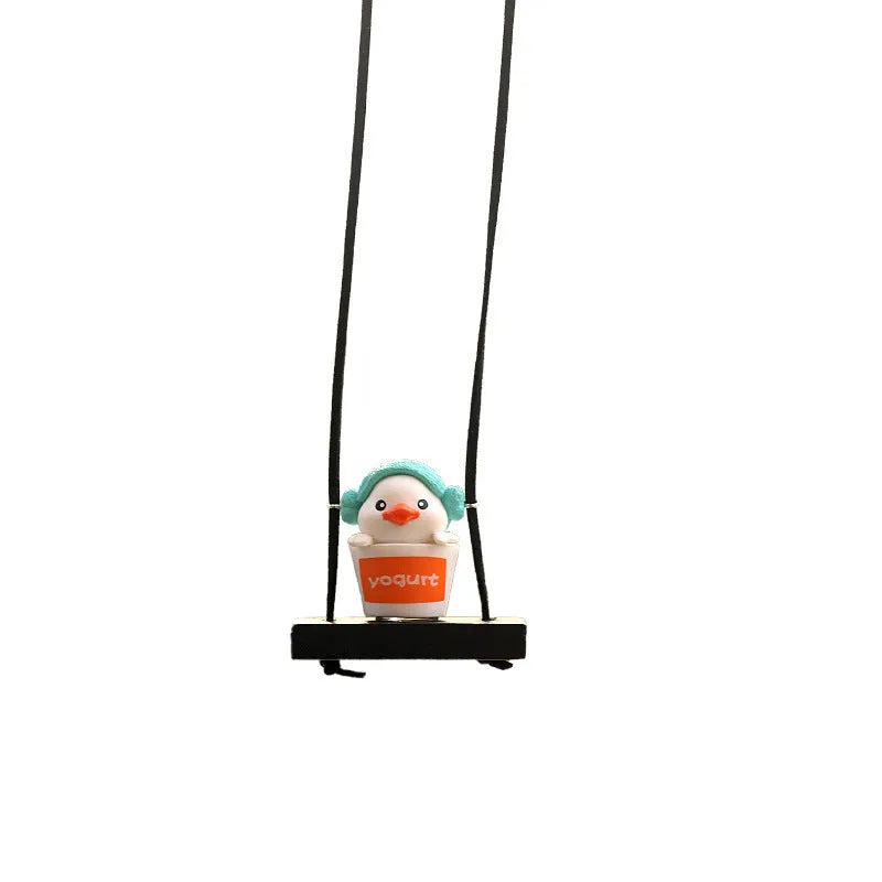 Colourful plastic cartoon duck car hanging ornament on a rear-view mirror.