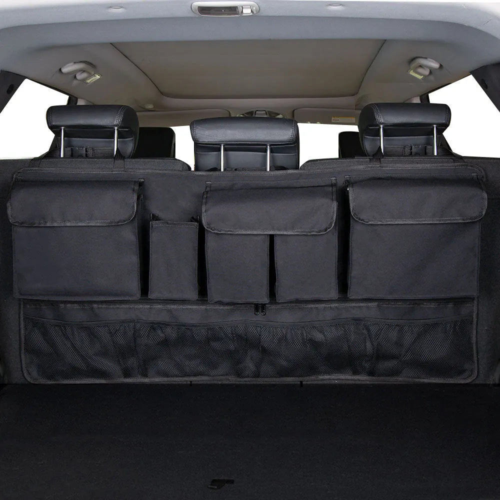 Car trunk hanging storage shopping bag in black with red piping, showing Oxford cloth construction and reinforced handle