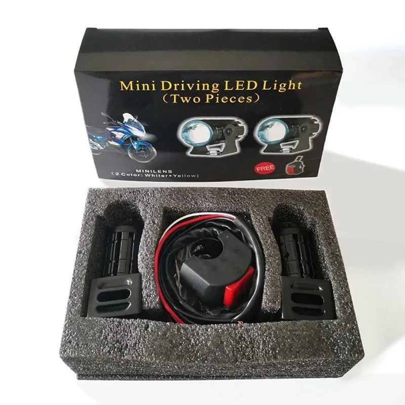 Motorcycle auxiliary spotlight with two-colour lens options, showing aluminium and polycarbonate housing.