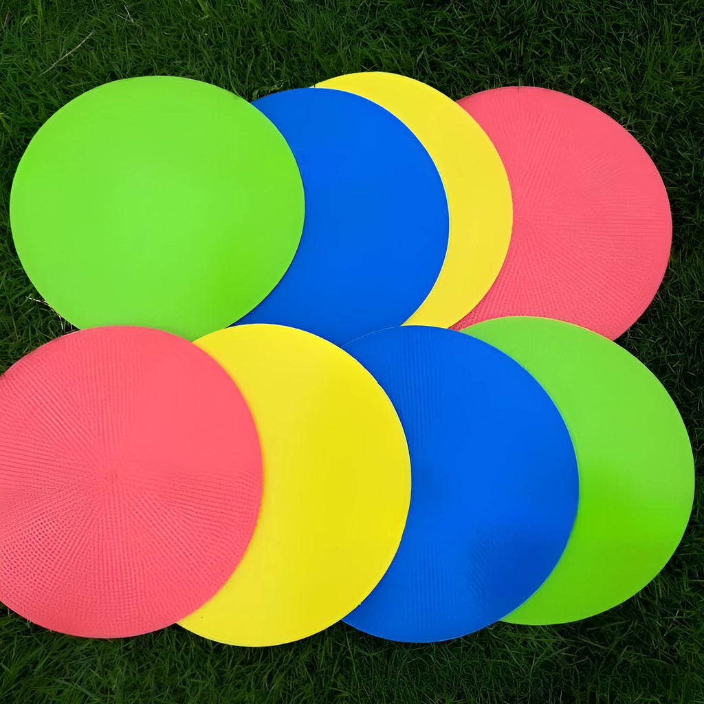 Circular yellow football training marker disc on grass field showing 23cm diameter