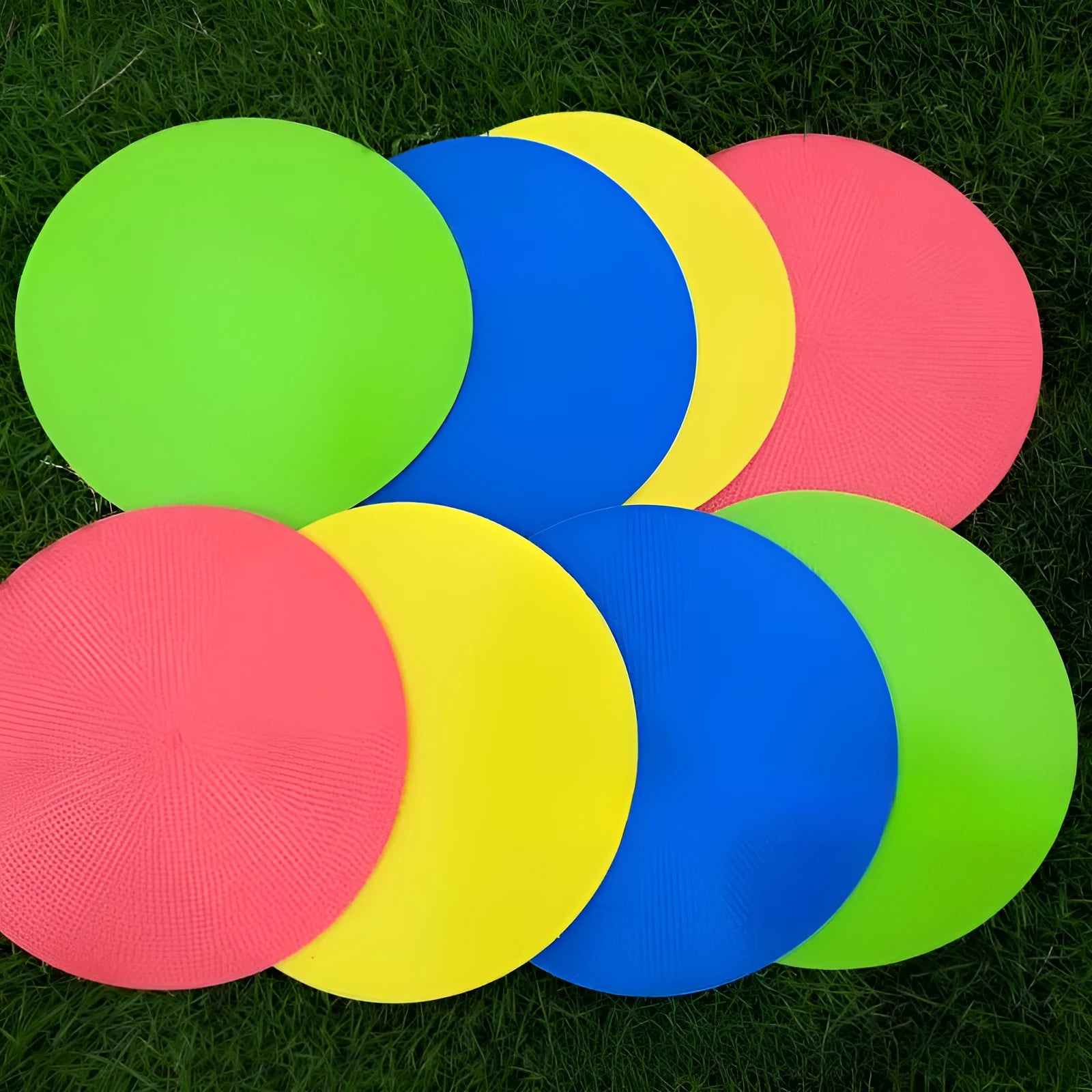 Circular yellow football training marker disc on grass field showing 23cm diameter