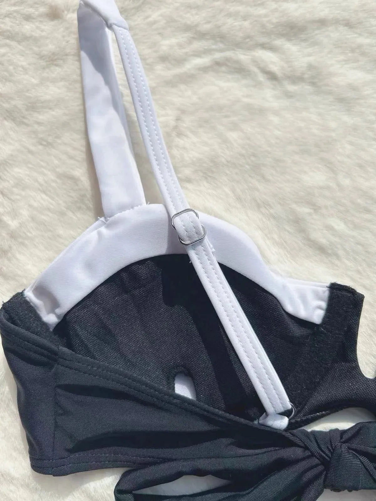 Black low waist women's bikini swimsuit with stitching split detail on the briefs.