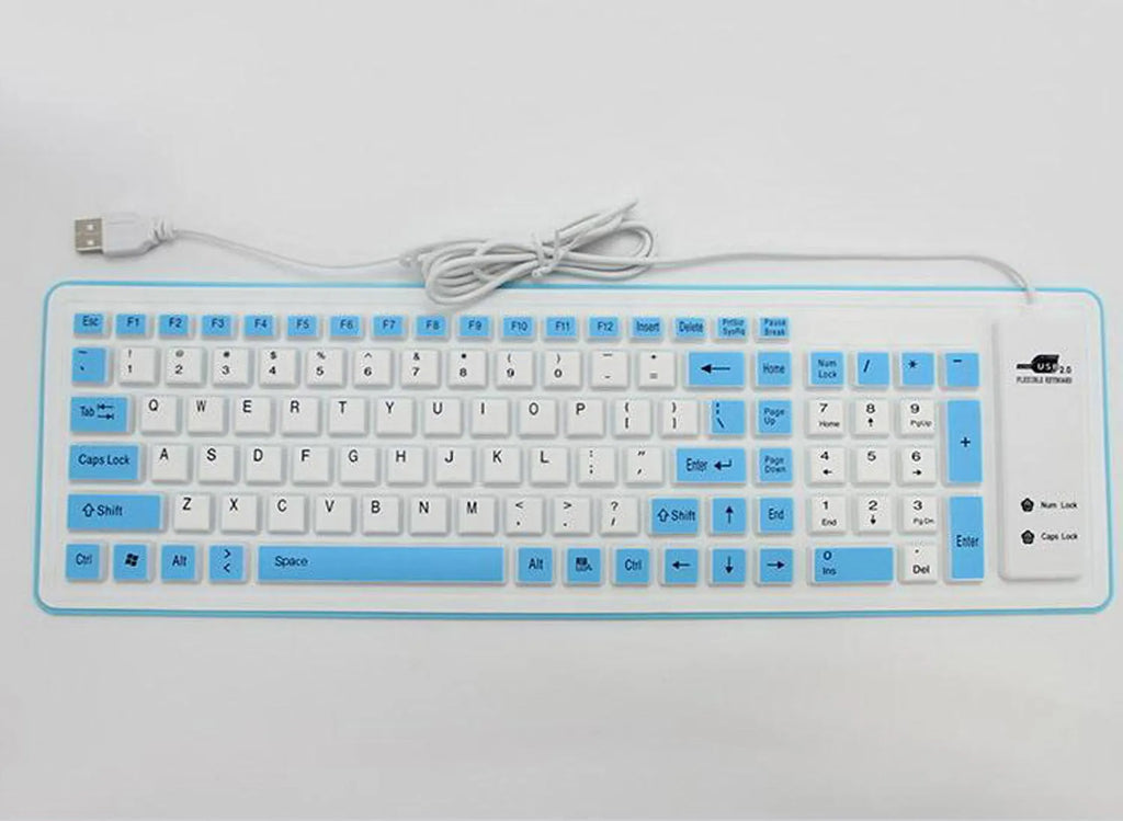 Folding silicone keyboard in pink with USB cable, placed on a desk