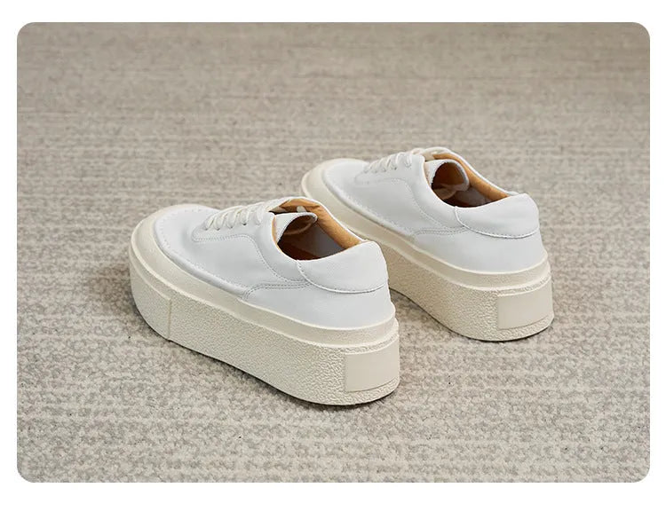 Women's black and white platform sports board shoes with embossed cowhide uppers and round toe design