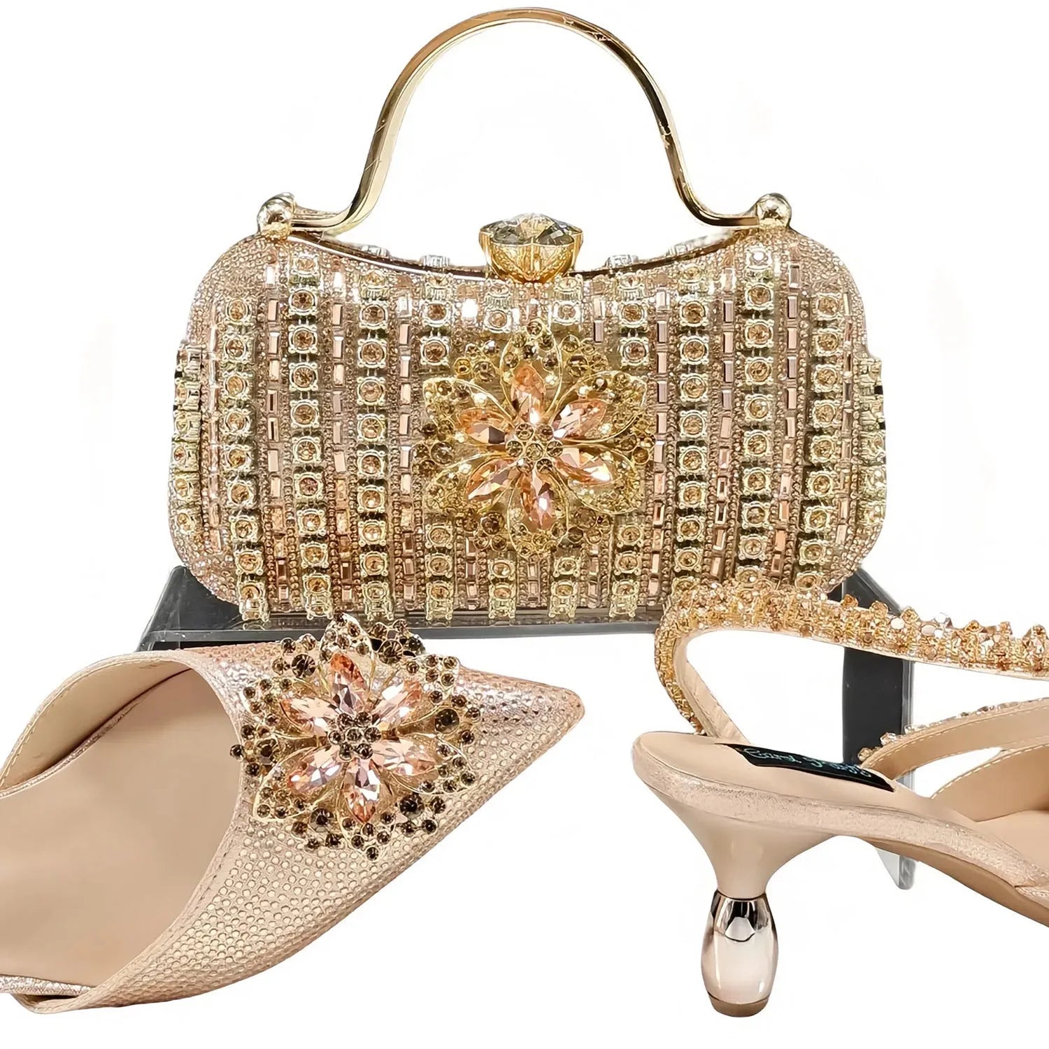 Women's black high heel shoe and matching clutch bag with floral rhinestone decoration and chain strap.