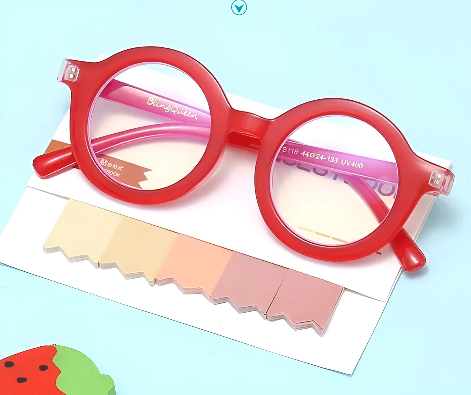Retro round frame anti blue light glasses in multiple colours on a plain background.
