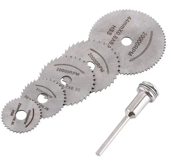 Six or seven high-speed steel circular saw blades and a mandrel on a grey background.